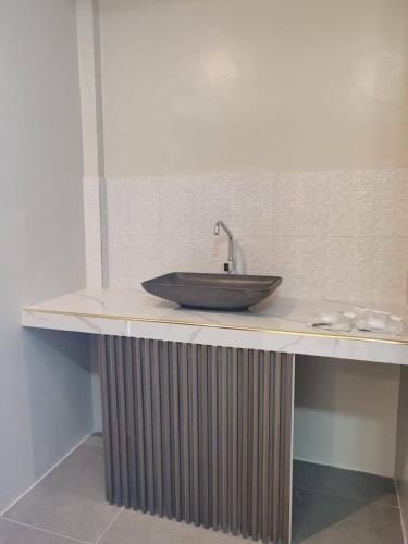 a sink on a counter in a bathroom at Wilson Hills Travelers Suites in San Juan