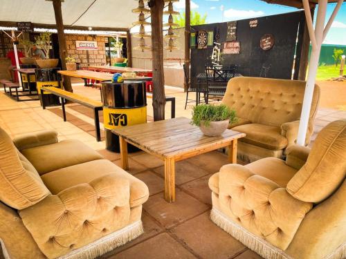 a room with couches and a table in a store at Gecko Accommodation in Hotazel