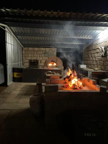 a large brick oven with a fire in it at Gecko Accommodation in Hotazel