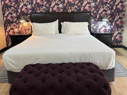 a large bed in a bedroom with a large bedskirts at Thabazimbi Country Lodge in Thabazimbi