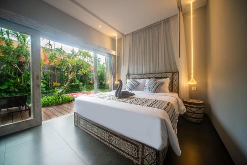 a bedroom with a large bed and a large window at Luxury-Sang Villa- Central Sanur in Sanur