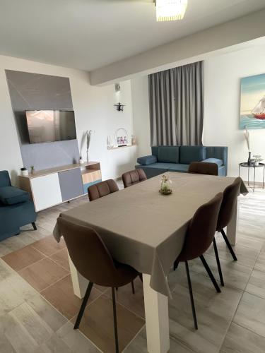 a dining room with a table and a living room at Accommodation Ventus 2 in Baška Voda