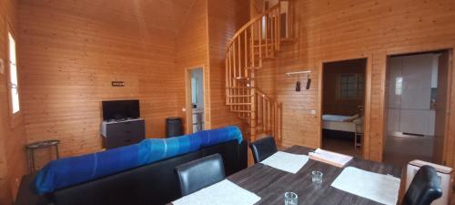 a room with two tables and a blue couch at Oporto SurfLodge in Cortegaça