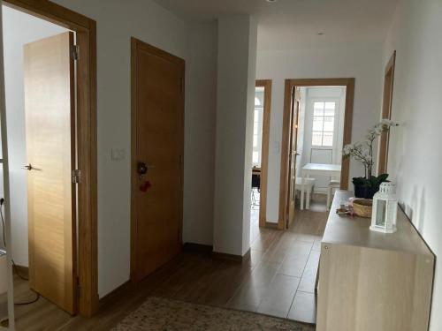 a room with a hallway with a door and a table at Grupo Gontad Casa Secundino in Asalo