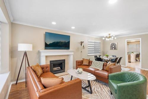 a living room with a couch and a fireplace at Spacious Family Retreat Central to YVR and Downtown in Vancouver