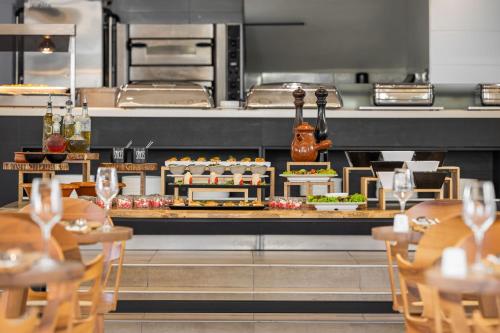 a restaurant with a counter with food on it at Cabana Blu Hotel & Suites in Kardamaina