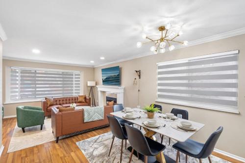 a living room with a table and chairs and a couch at Spacious Family Retreat Central to YVR and Downtown in Vancouver