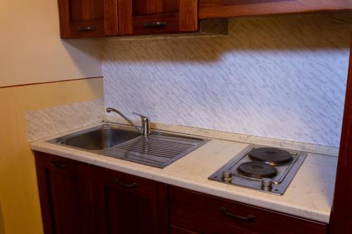 a kitchen with a sink and a stove at Vicolo de Ascesi in Assisi