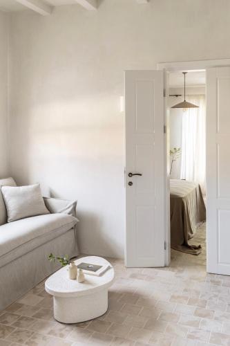 a living room with a couch and a table at Om Living Pelion in Agios Dimitrios