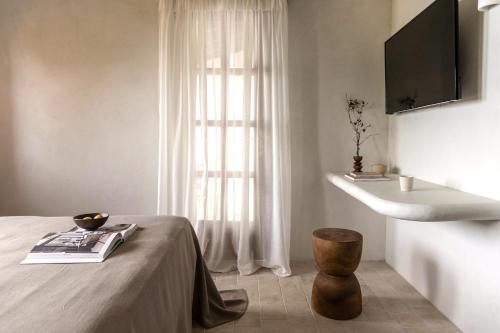 a bedroom with a bed and a sink and a table at Om Living Pelion in Agios Dimitrios