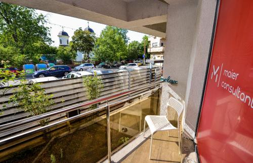 a chair sitting on the balcony of a building at Bucharest Accommodation Apartments in Bucharest