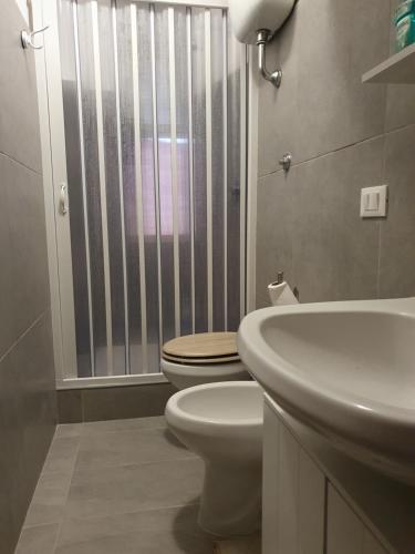 a bathroom with a toilet and a sink at La mandragola in Rome