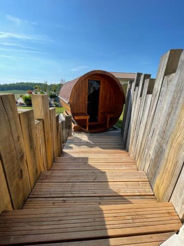 a wooden boardwalk with a wooden tent on it at Plaisir d'Eymet du Domaine des Hauts de Rouquette in Eymet