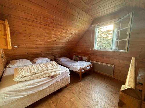 a room with two beds in a wooden cabin at La Farandole, coastal family home in Agon Coutainville