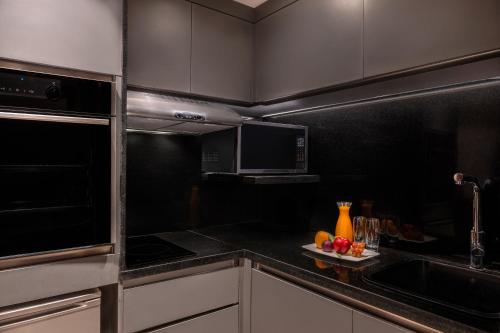 a kitchen with a sink and a microwave at Sofitel Cairo Downtown Nile in Cairo