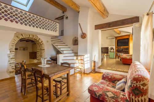 une cuisine et un salon avec une table et des chaises dans l'établissement Le Cabanon des Cigales en Provence - Avec Piscine, à Puyméras