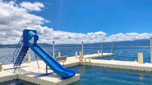 a blue water slide in the middle of the water at Casa en la Nueva Puntilla in Villarrica