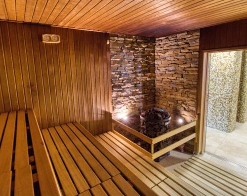 a inside of a sauna with a stone wall at Na samotě u lesa in Vsetín