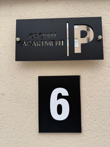 a sign on a wall with the number at CROWN apartment 3 in Subotica