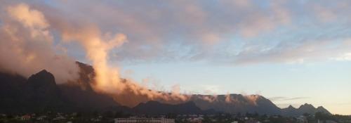 a view of a mountain with smoke coming out at Au Coeur du Paradis in Cilaos