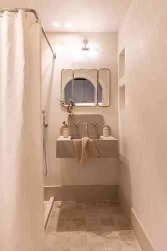 a bathroom with a sink and a mirror at Om Living Pelion in Agios Dimitrios