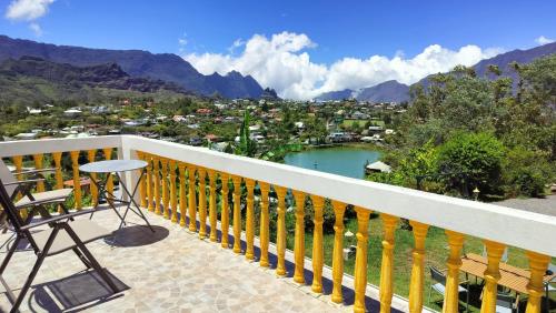 a balcony with a view of a town and mountains at Au Coeur du Paradis in Cilaos