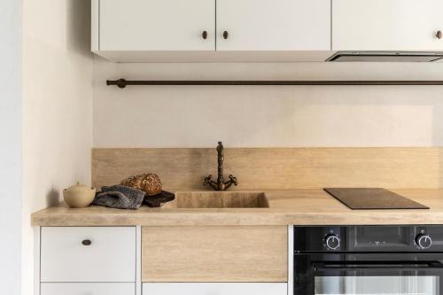 a kitchen with a sink and a stove at Om Living Pelion in Agios Dimitrios