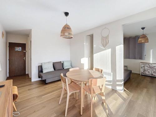 une salle à manger et un salon avec une table et des chaises dans l'établissement Appartement rénové 5 pers. avec parking, à 100m plage, centre Merville-Franceville, expo Sud - FR-1-465-71, à Merville-Franceville-Plage