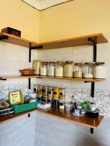 a kitchen with a counter with many pots and pans at Rafah Apartment in Namugongo