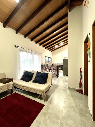 a bedroom with a bed with blue pillows on it at Sossego e Boa Vista in Ilhabela