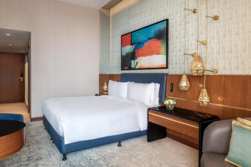 a hotel room with a bed and a couch at Sofitel Cairo Downtown Nile in Cairo