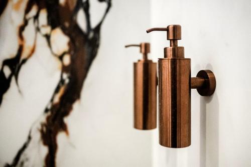 two bronze fire hydrants hanging on a wall at Villa335 boutique b&b in Amsterdam