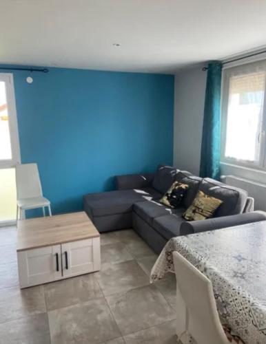 a living room with a couch and a table at Le Gîte des Alleux in Saint-Julien