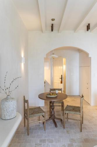 a dining room with a table and chairs at Om Living Pelion in Agios Dimitrios