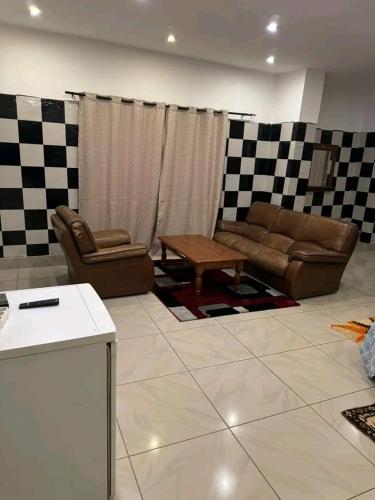 a living room with a couch and a table at Motel Africa pas Chers in Conakry