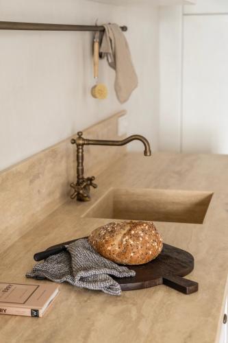 a bagel sitting on a counter next to a sink at Om Living Pelion in Agios Dimitrios