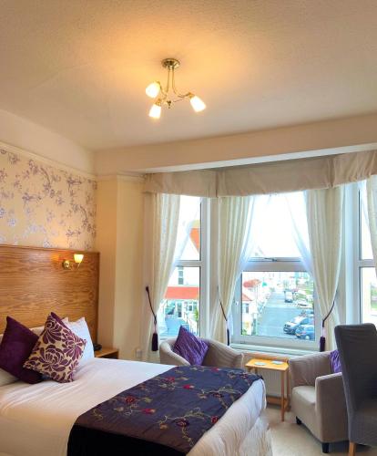 a hotel room with a bed and a window at The Briars - Adults Only in Paignton