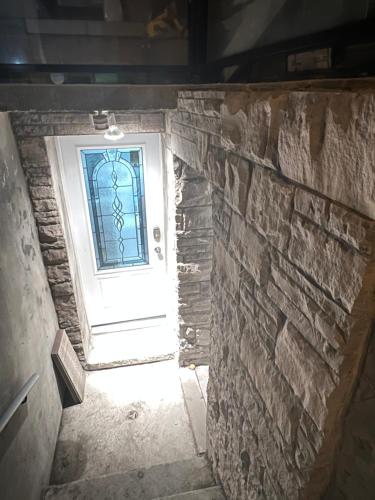 a stairway leading to a door with a window at Stylish City Escape in Toronto