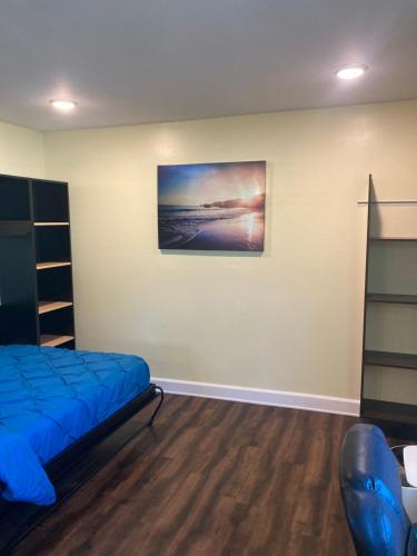 a bedroom with a bed and a painting on the wall at Chic studio with WI FI and AC in Sarasota
