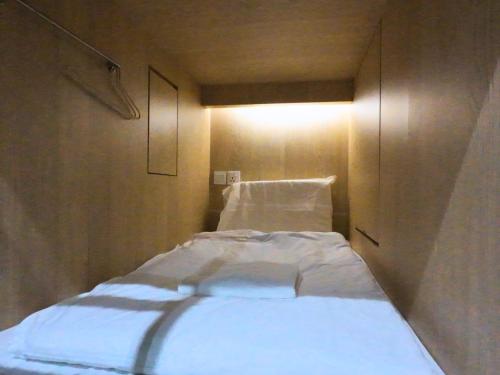 a small room with a bed in the corner at The Room @ Bugis in Singapore