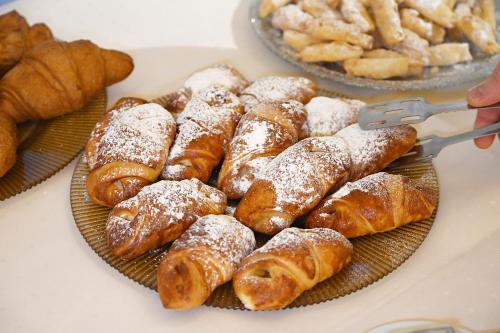 a bunch of pastries on a plate on a table at Nadiya Hotel in Ivano-Frankivsʼk
