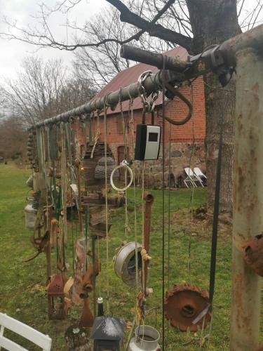 a group of old items hanging from a tree at Landhaus Lange3 Moderne Kunst in Poitendorf