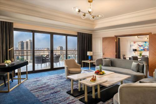 a living room with a couch and a table at Sofitel Cairo Downtown Nile in Cairo