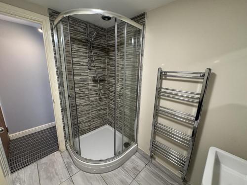 a shower with a glass door in a bathroom at The Kings Head inn in Addlethorpe