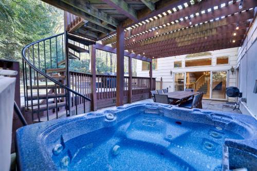 a hot tub in the middle of a patio at Luxury Villa with Year Round Heated Pool, Sauna, Spa & Fire Pit - Newly Redone in East Stroudsburg
