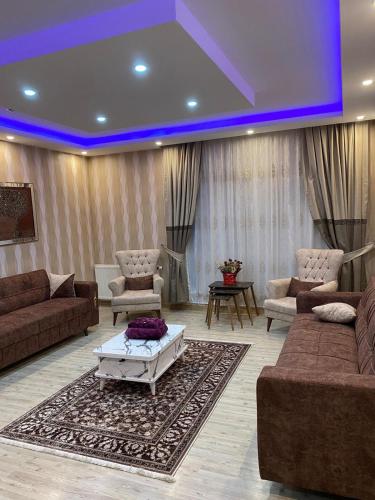 a large living room with couches and a blue light at ENTIRE 3 Bedroom Apartment with FREE PARKING in Esenyurt