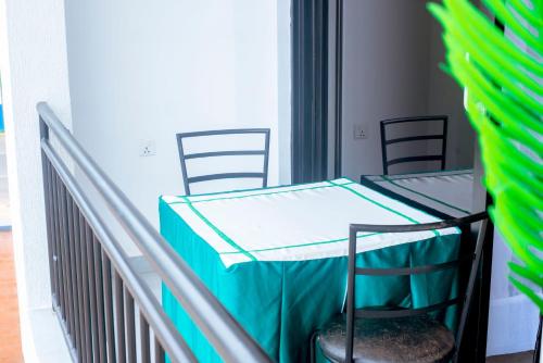 a balcony with a table with a blue table cloth at Martin Aviator Apartment in Kigali