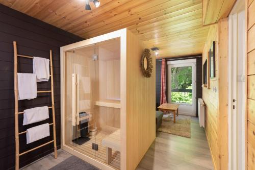 a bathroom with a large glass door in a house at LOGIS Hôtel Restaurant La Vigotte in Girmont-Val-dʼAjol