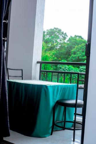 a table and two chairs on a balcony at Martin Aviator Apartment in Kigali