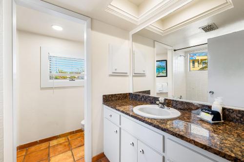 a bathroom with a sink and a mirror at Fanta-Sea 47 By Beachside Management in Siesta Key